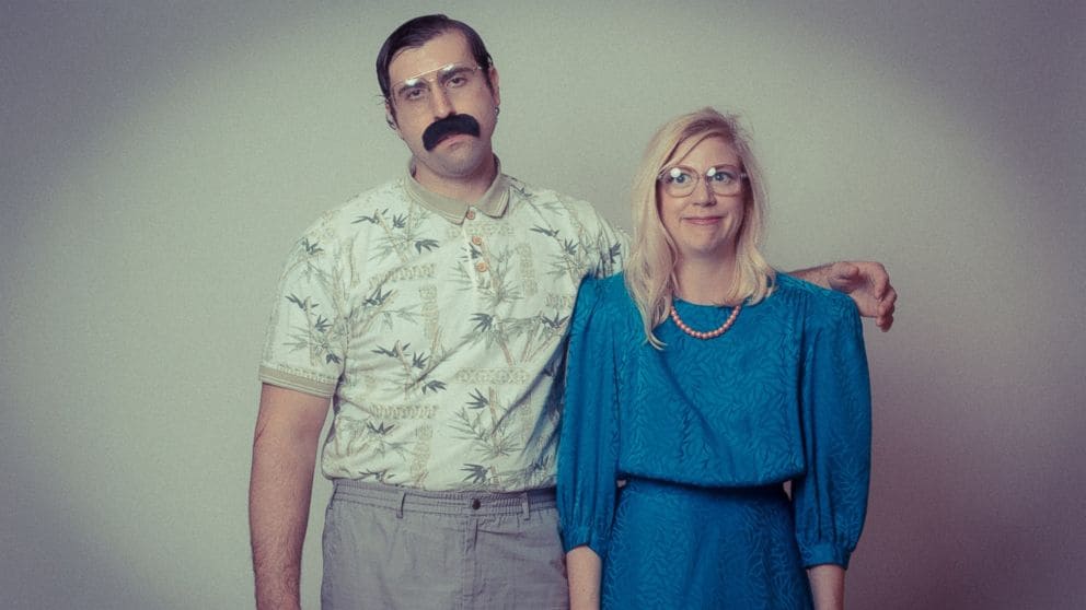 a man and a woman wearing awkward 70's clothing