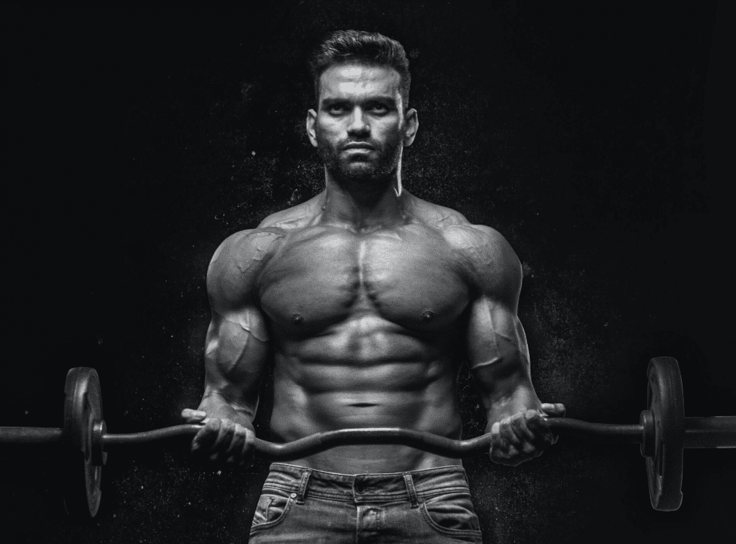 man shirtless holding a barbell, doing bicep curls, black and white photo