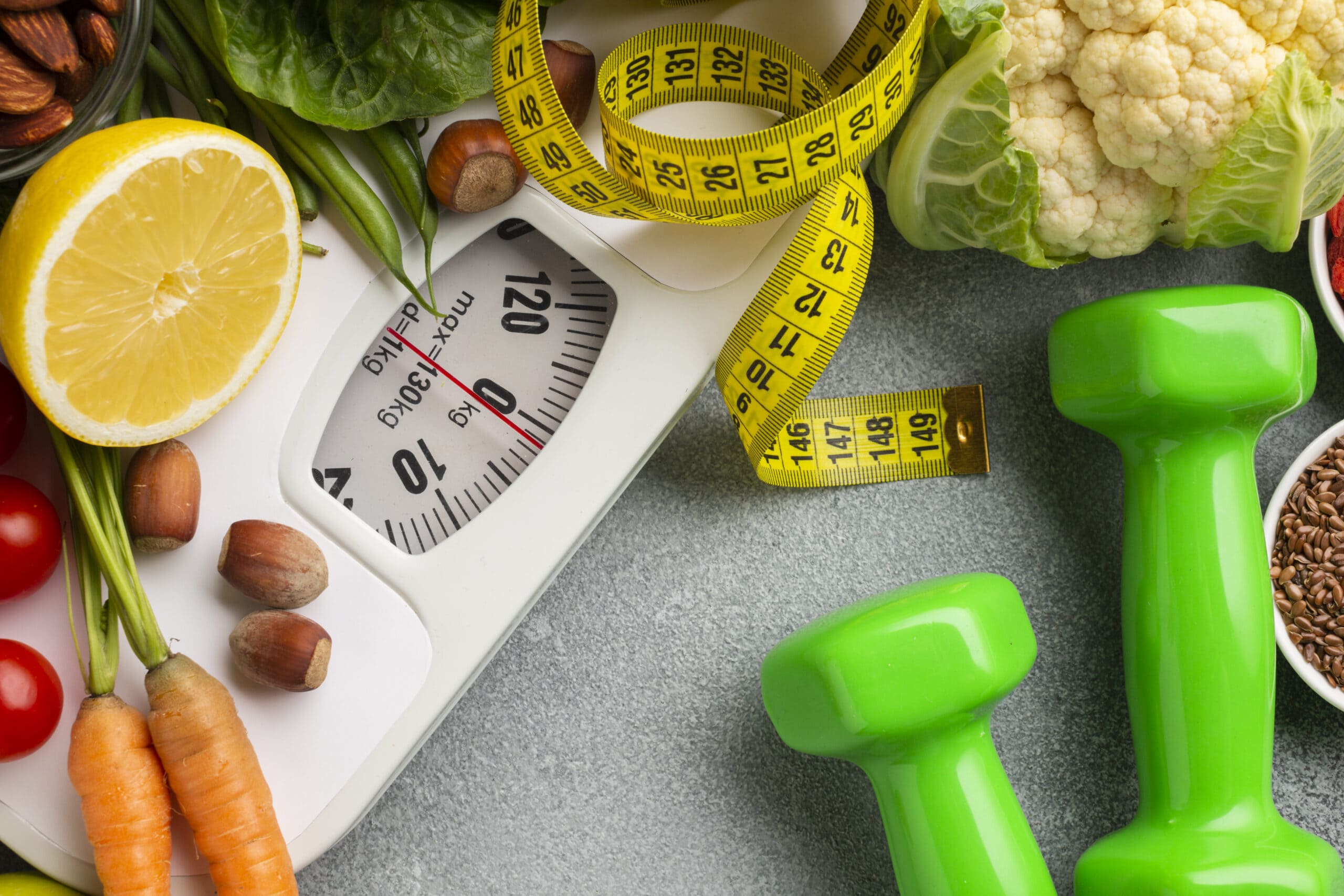 picture filled with a scale, measuring tape, dumbbells and vegetables