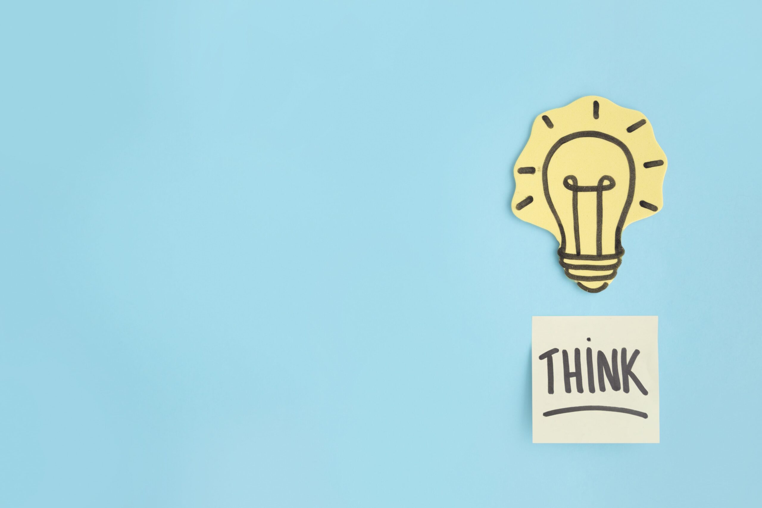 think-sticky-note-hand-drawn-yellow-light-bulb-blue-background