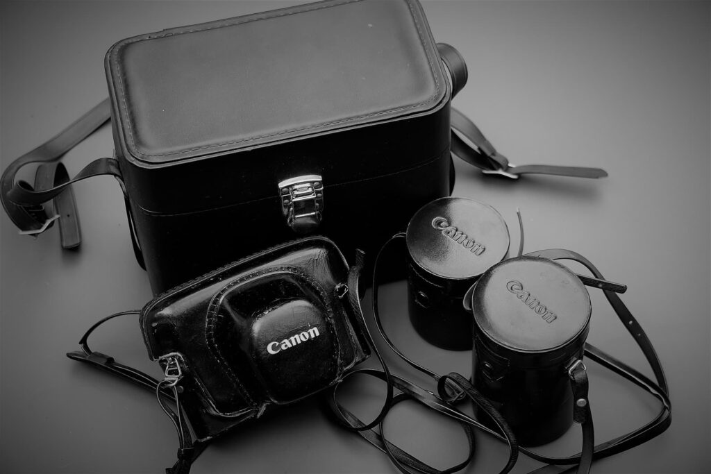 camera-camera bag- lenses-on black table